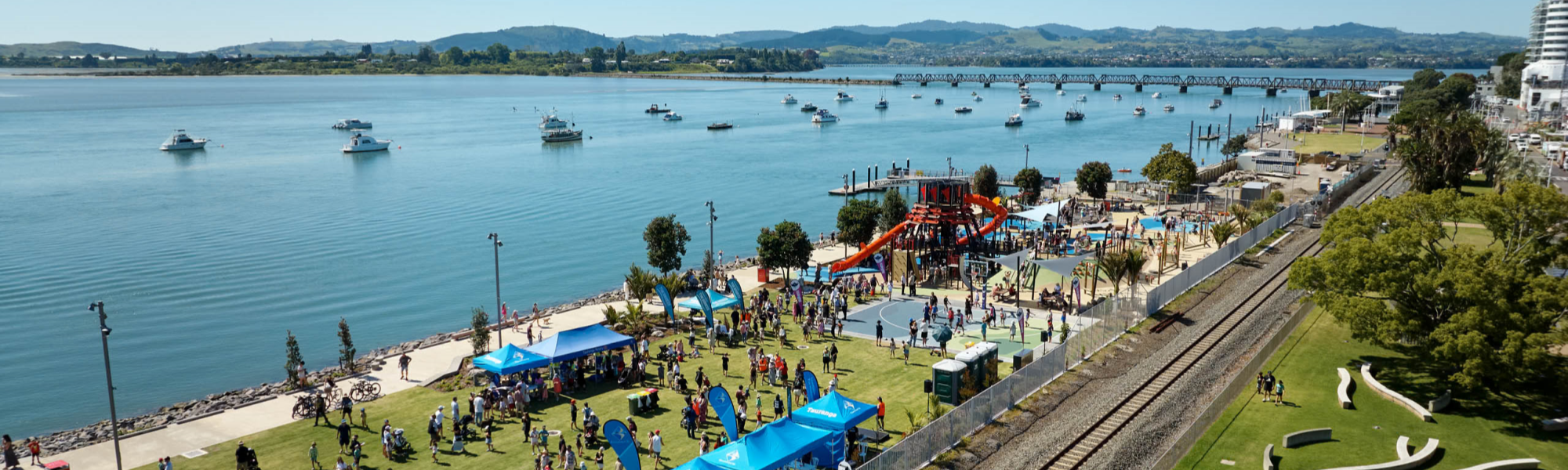 Tauranga waterfront with people in the playground and greenspace